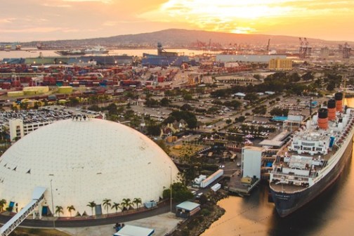 a small boat in a body of water with a city in the background