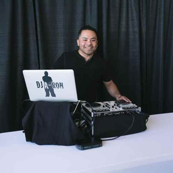 a woman sitting at a table in front of a curtain