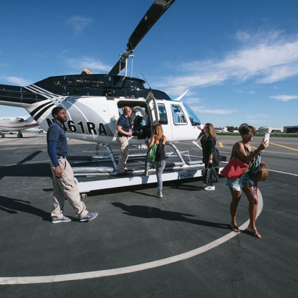 a group of people standing around a plane