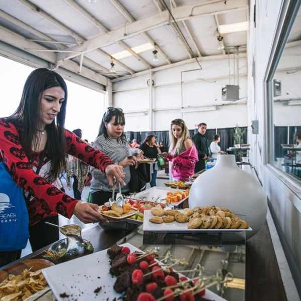 a group of people preparing food on a table