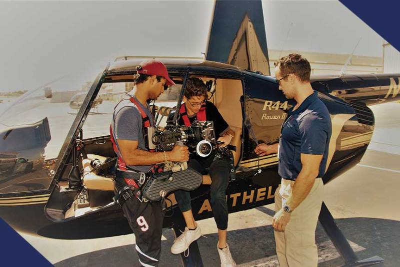 a man standing next to a plane