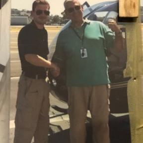 a person standing in front of a group of people posing for the camera