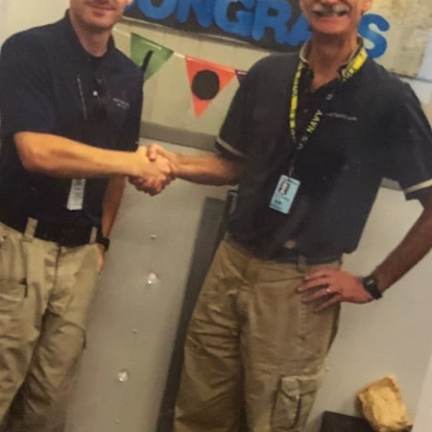 a person standing in front of a group of people posing for the camera