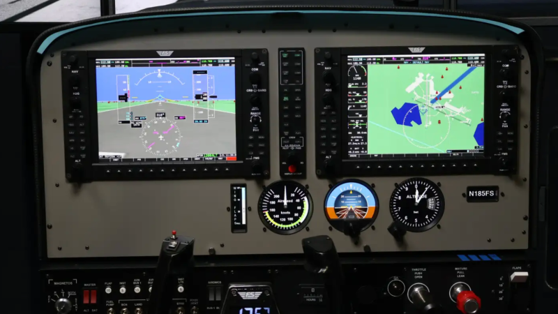 Aircraft cockpit with digital displays and control panel.