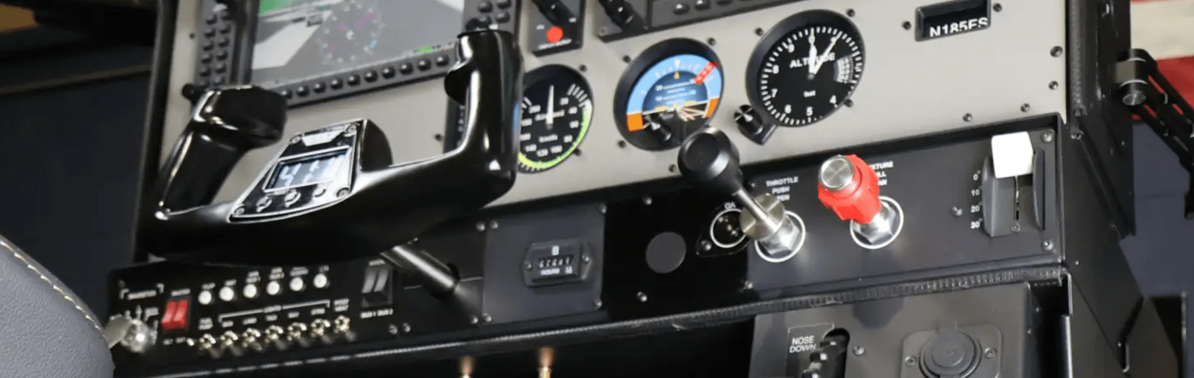 Aircraft cockpit panel with gauges and control yoke.